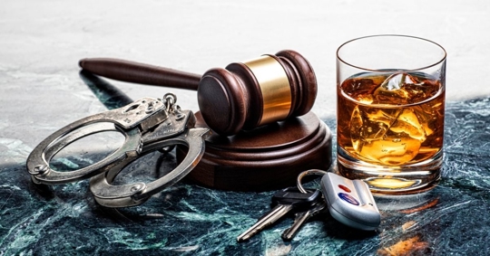 Drinking and Driving Handcuffs and Gavel on Marble Background