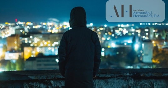 Man silhouette against night city background.
