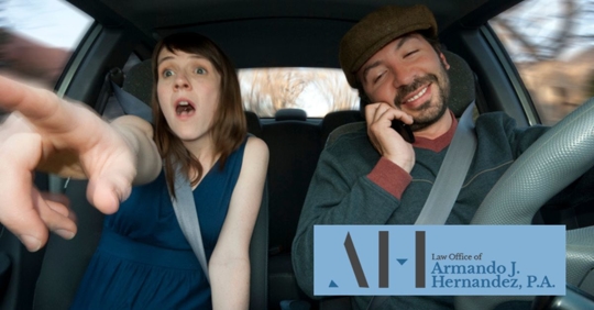 man on phone while driving