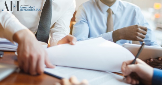 individuals going over paperwork at a table
