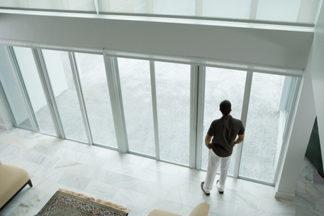 man looking out window in Miami